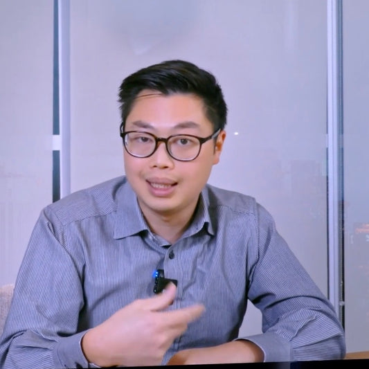 Image of Prosthodontist Dr. Got Sui appearing to be speaking to a camera. He is wearing a lapel mic on his blue collared shirt.